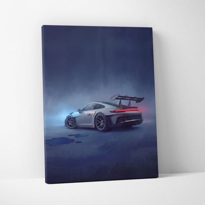 A sleek silver porsche 911 gt3 rs canvas print showing the rear view with red taillights and wing in a misty backdrop
