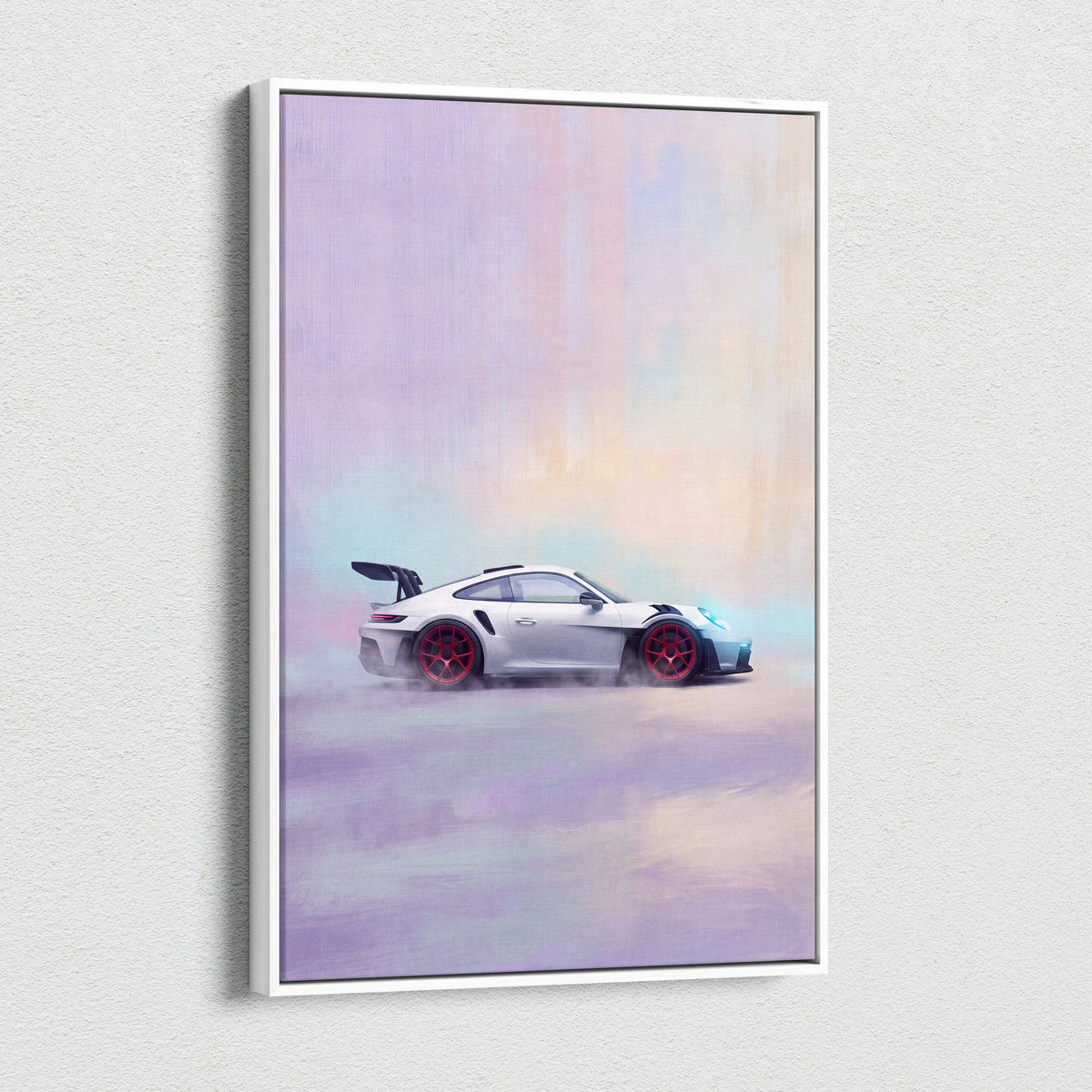 A framed canvas print of a white Porsche 911 GT3 RS with red wheels in motion against a pastel sky wall art