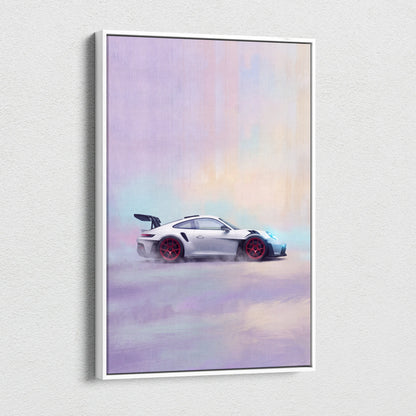 A framed canvas print of a white Porsche 911 GT3 RS with red wheels in motion against a pastel sky wall art