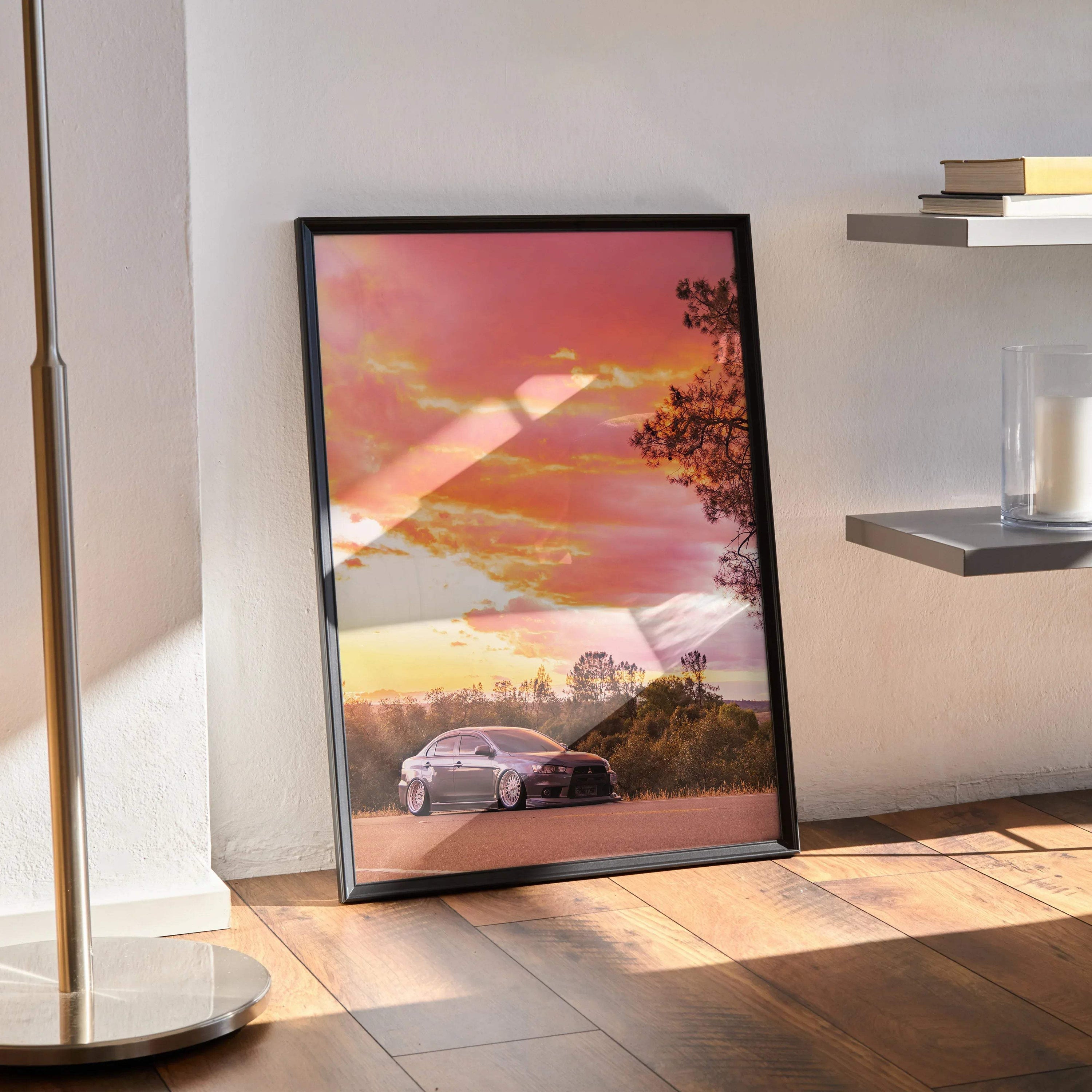Mitsubishi Evo X poster wall art with sunset sky and silhouetted trees in black frame.