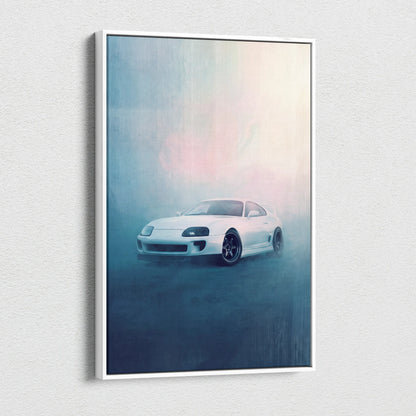 White framed canvas print featuring a sleek white Toyota Supra sports car in motion against a misty blue and pink background