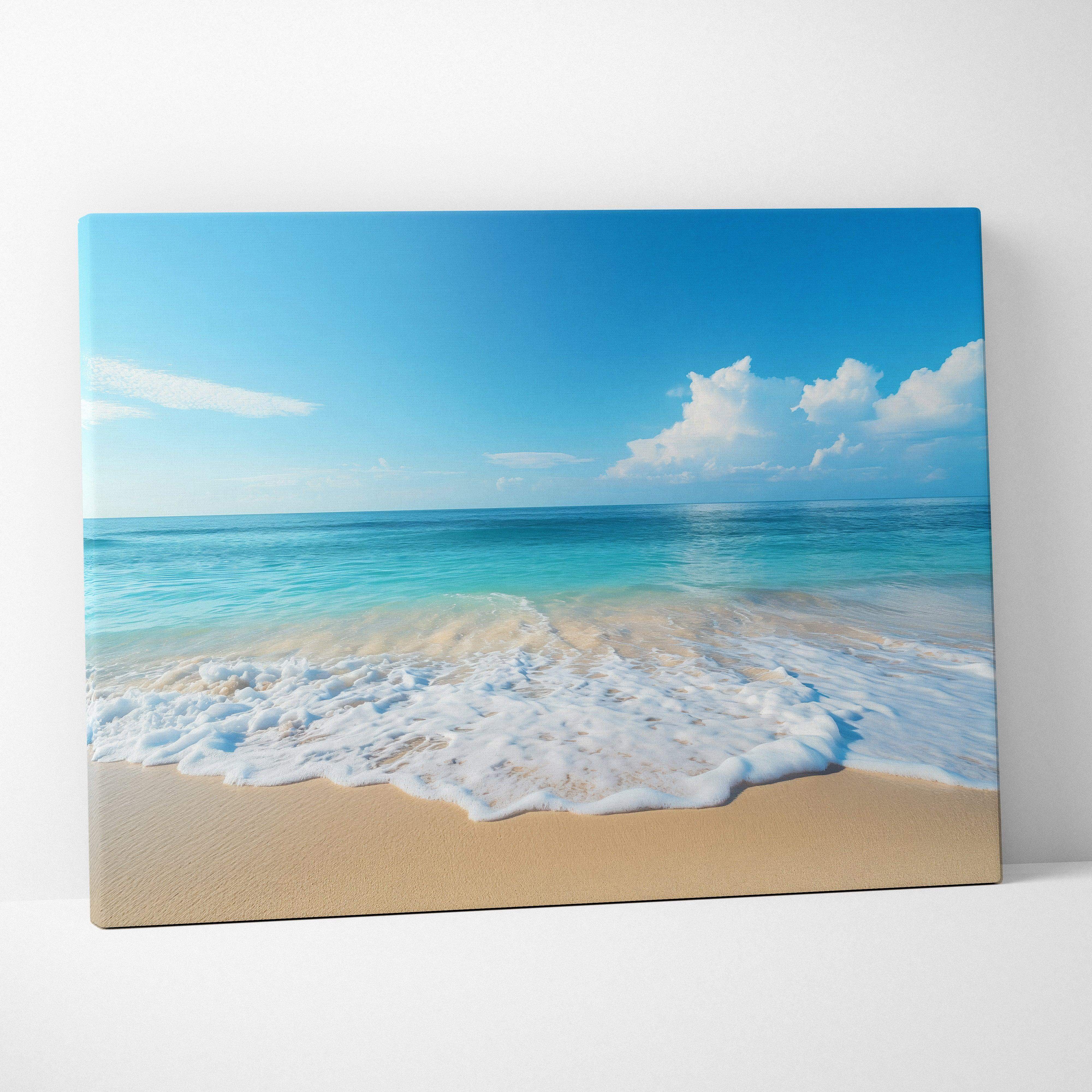 Calm beach scene canvas wall art featuring turquoise waves and golden sand under a bright blue sky with white clouds
