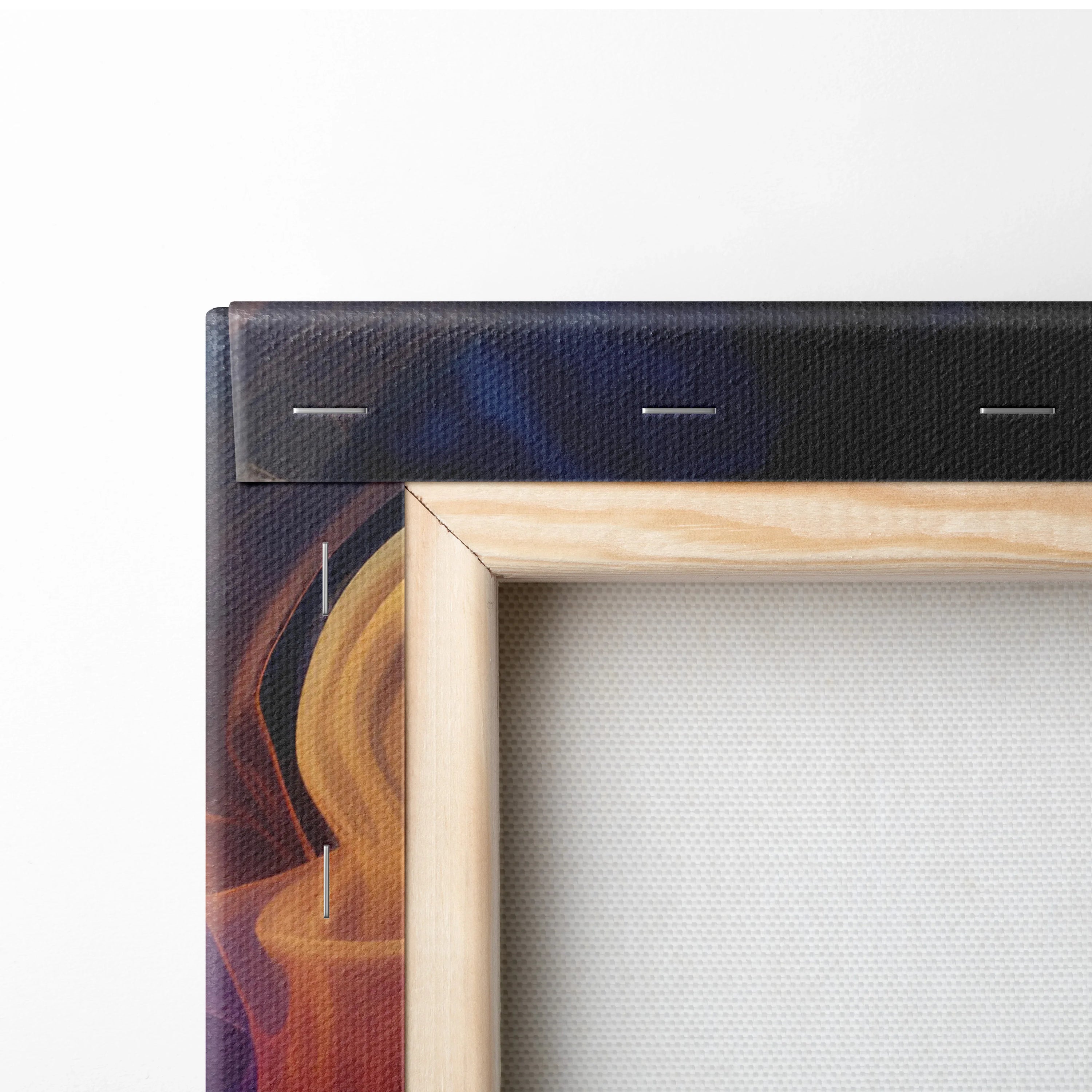 Close-up of corner of digital canvas wall art with natural wood frame and dark abstract design on textured canvas.