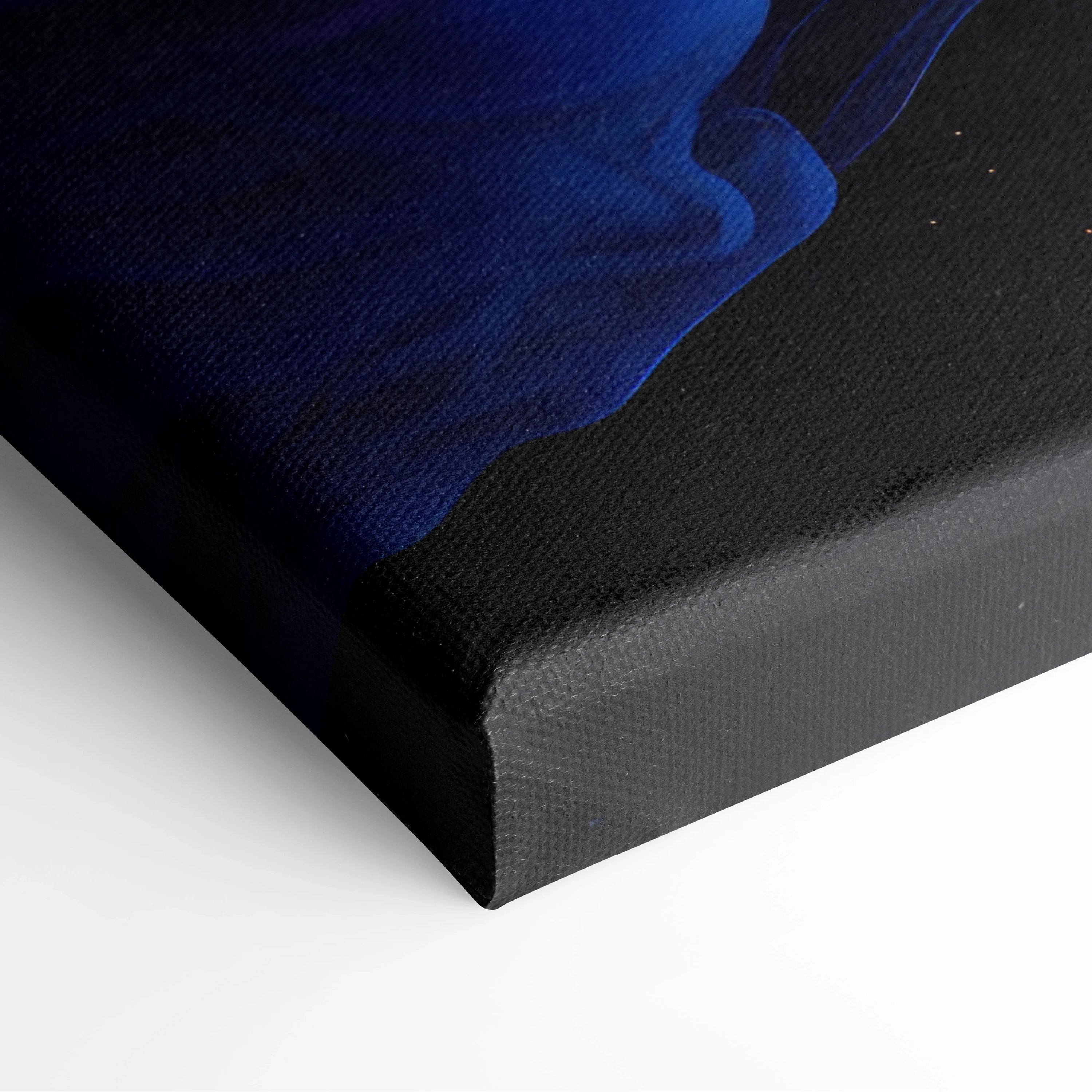 Close-up of black canvas wall art with flowing deep blue abstract digital design on textured fabric surface.
