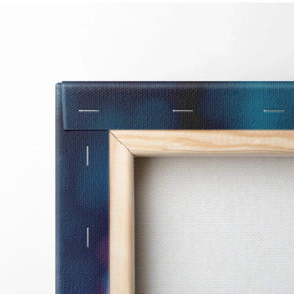 Close-up of stretched canvas art print with wooden frame and dark blue abstract edges.