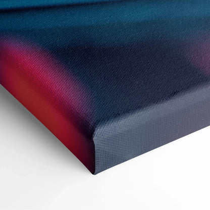 Close-up of modern abstract canvas wall art featuring blue and deep red gradient with smooth texture.