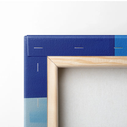 Corner of a stretched canvas with vibrant blue and light blue abstract cityscape design, wooden frame visible.