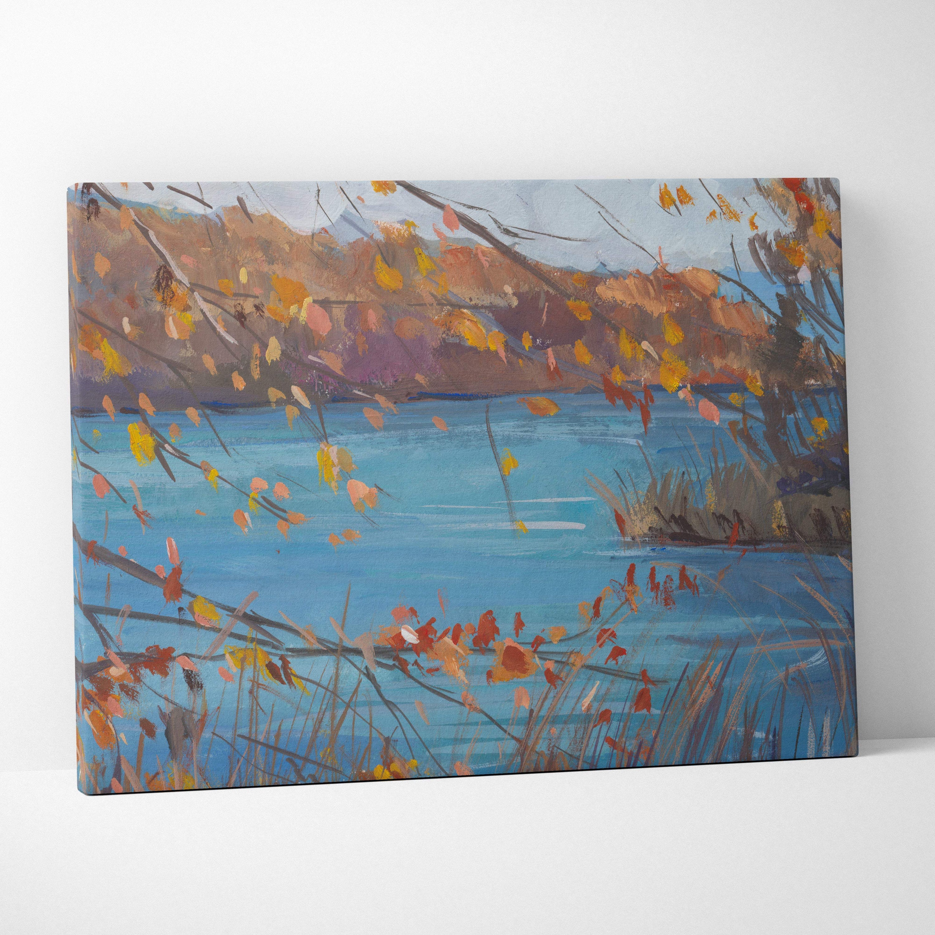 A rectangular autumn lake canvas print featuring impressionistic blue water and orange yellow fall leaves wall art