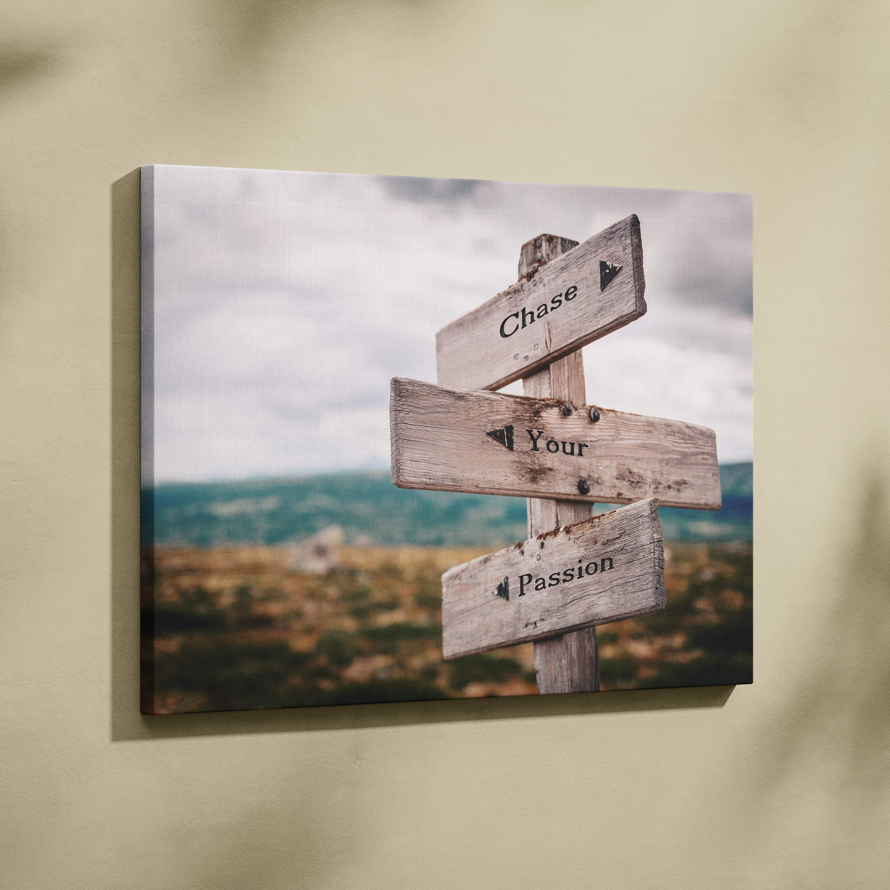 Weathered wooden signpost canvas print with three rustic grayish brown directional signs reading chase your passion for office or home decor