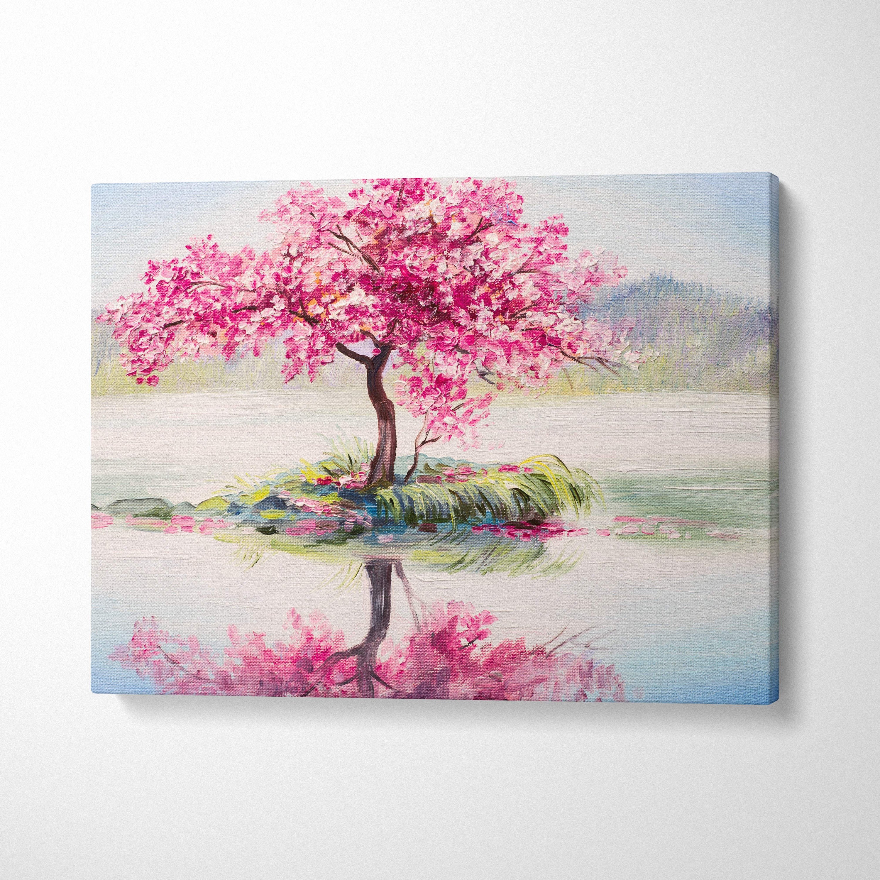 A vibrant pink cherry blossom tree painting on stretched canvas with bold brushstrokes and serene lake reflection
