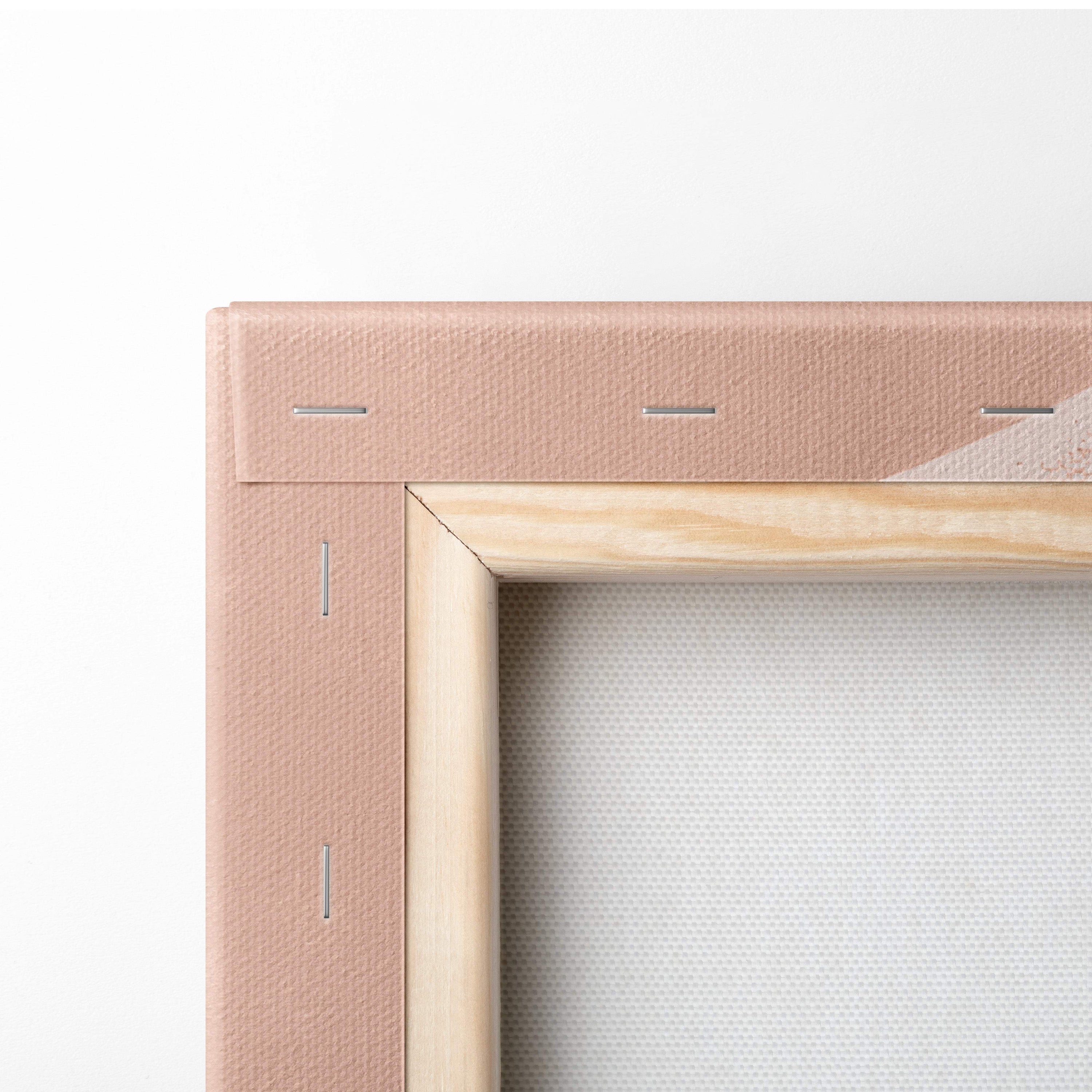 A blush pink canvas frame with light wood border and visible stitching in boho abstract geometric wall art design