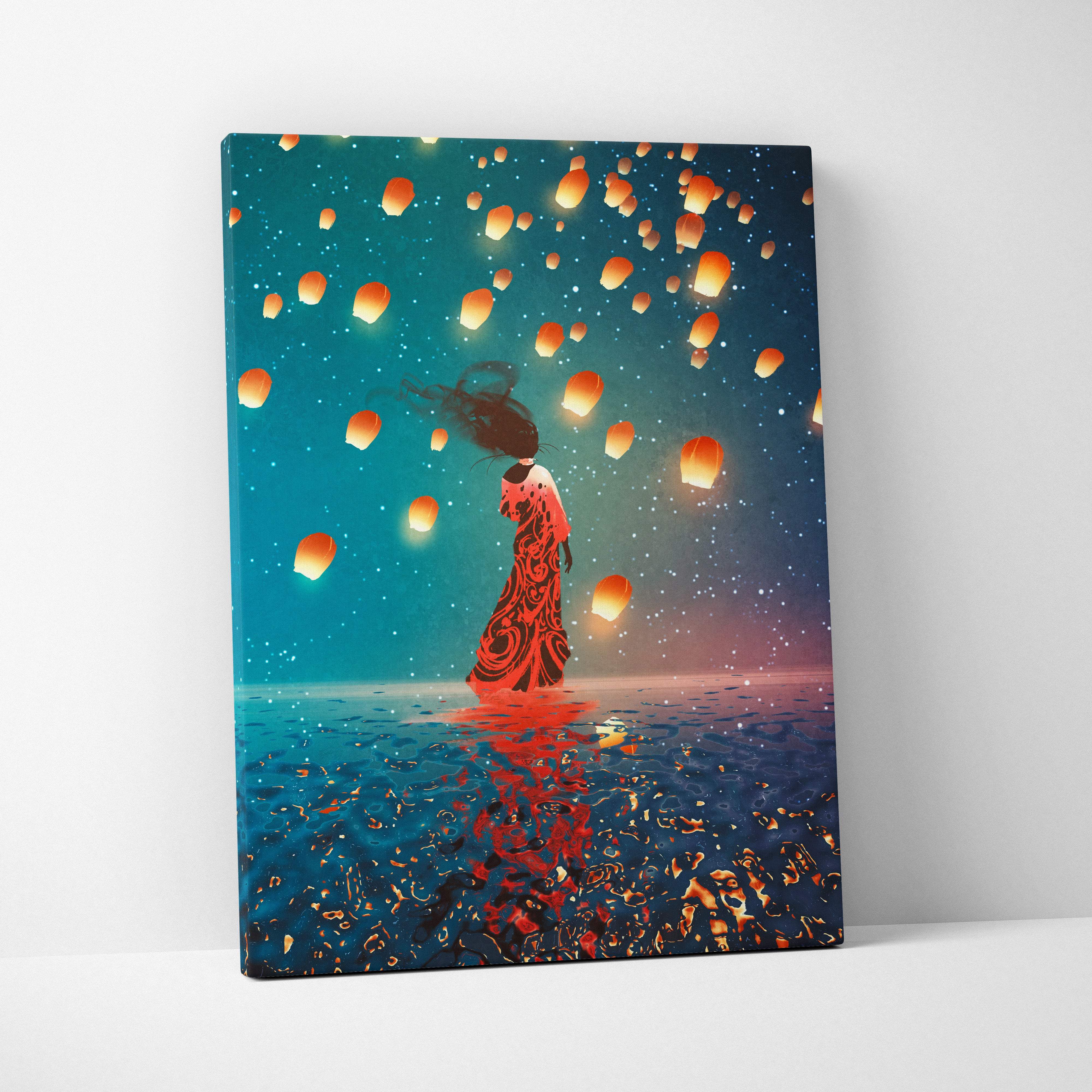 A canvas print of a woman in a red dress standing in water under glowing orange lanterns in a teal night sky