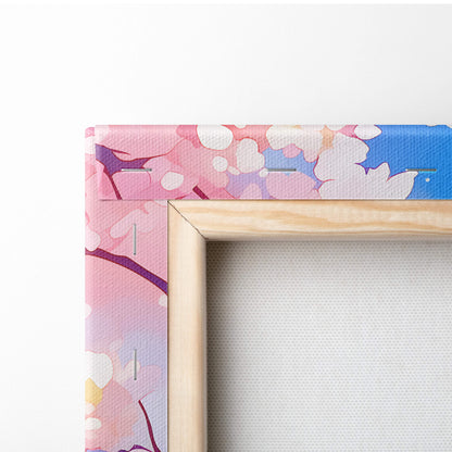 A wooden-framed canvas print of pink cherry blossom blossoms on a soft pink and blue gradient background