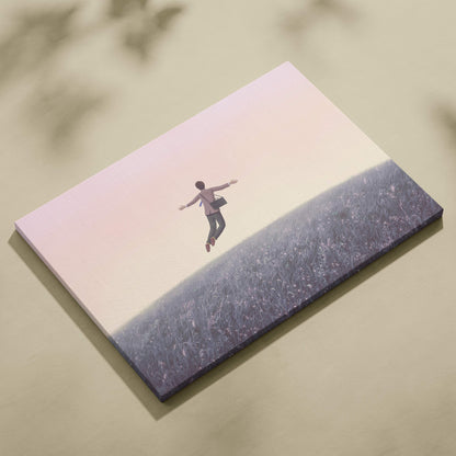 Contemporary floating man canvas wall art depicting a minimalist figure leaping over grass under a pastel pink sky