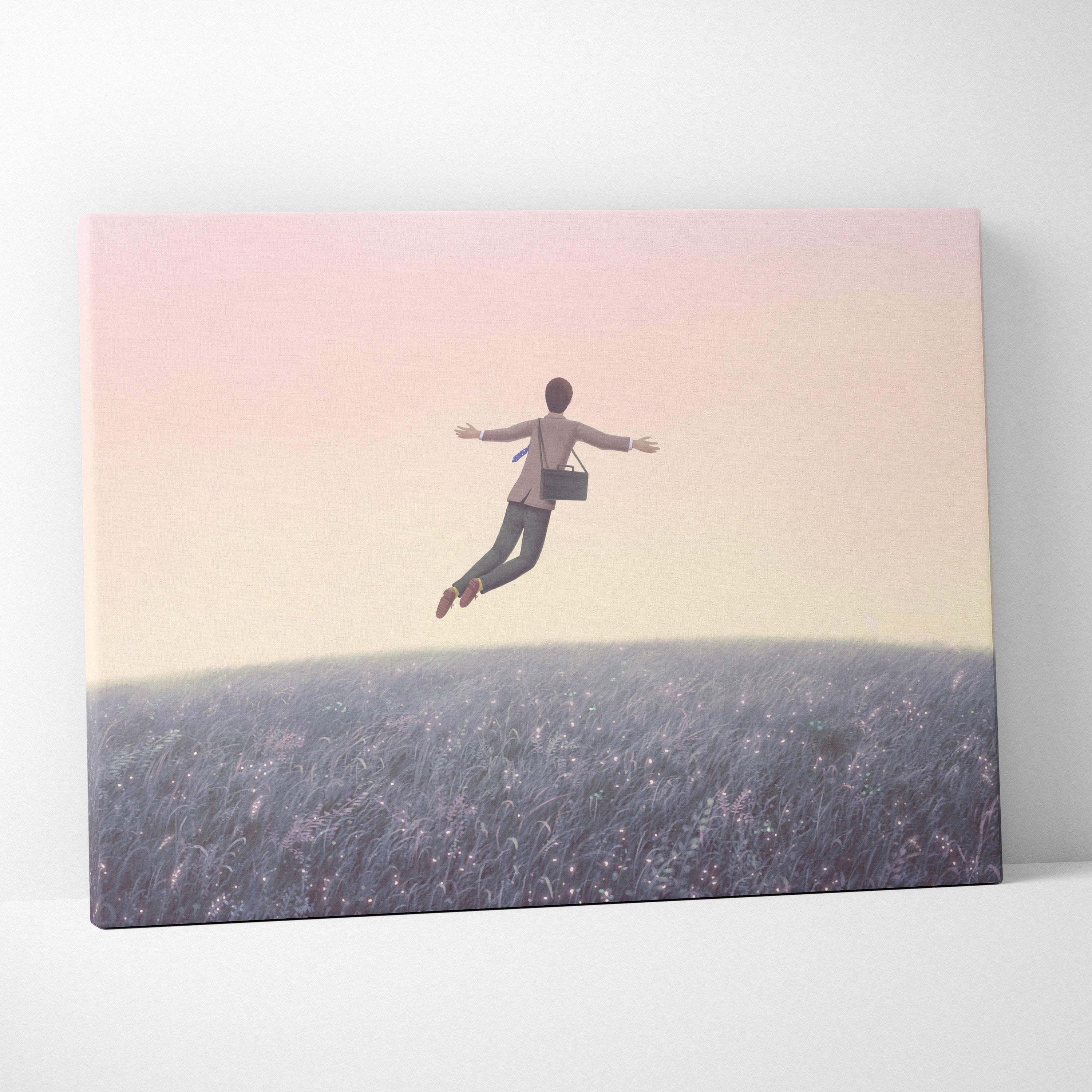 A rectangular canvas print of a floating man above purple grass under a pastel pink and yellow sky for modern decor