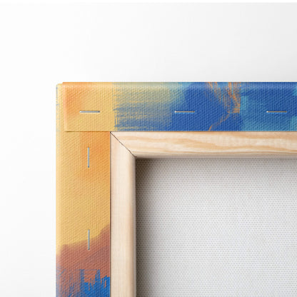 A wooden-framed canvas print featuring a vibrant abstract design with blended orange yellow and blue brushstrokes