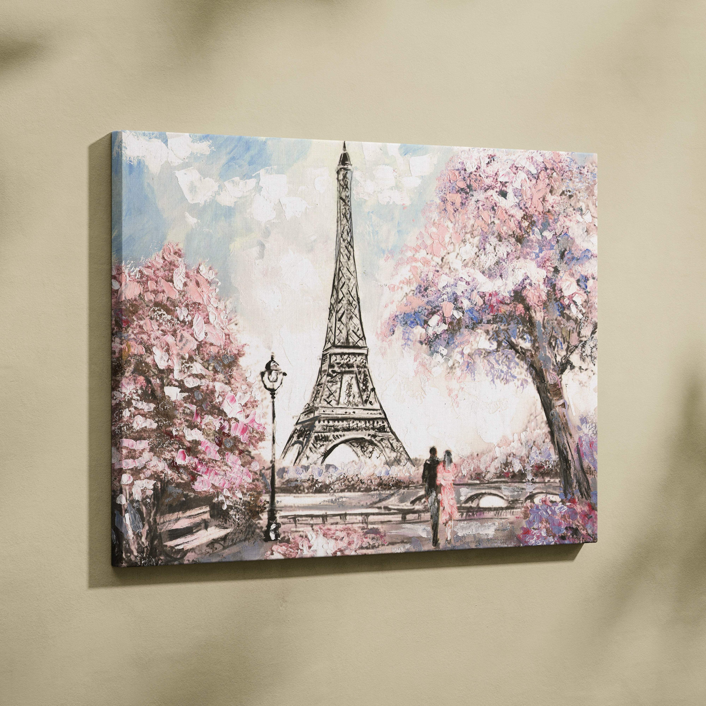 A canvas painting wall art of the eiffel tower surrounded by pink cherry blossoms and a couple walking in pastel tones