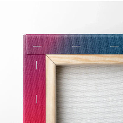 Close-up of vibrant pink and blue abstract canvas wall art with natural wood frame edges and visible staples.