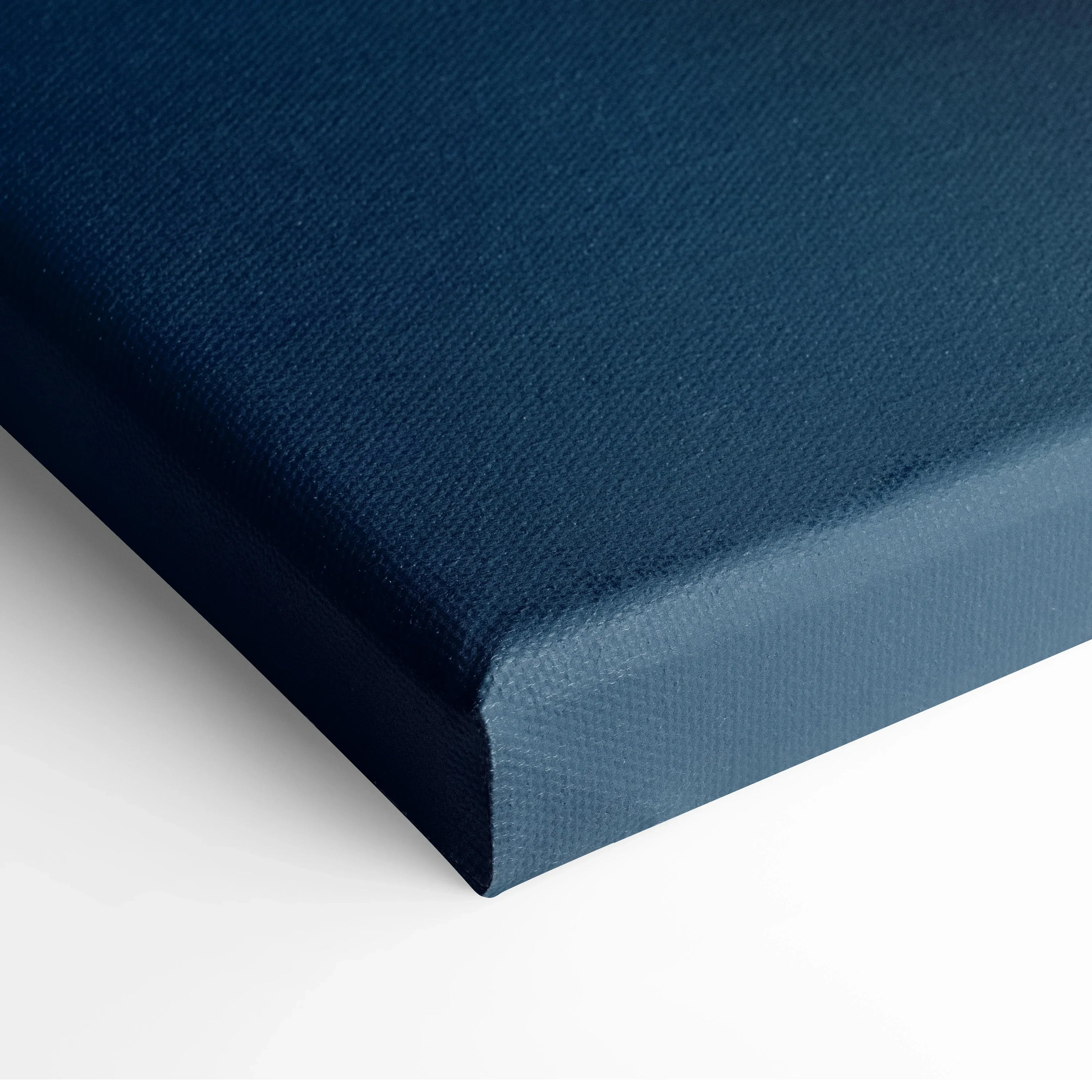 Close-up of blue canvas wall art corner with textured surface and clean edge.