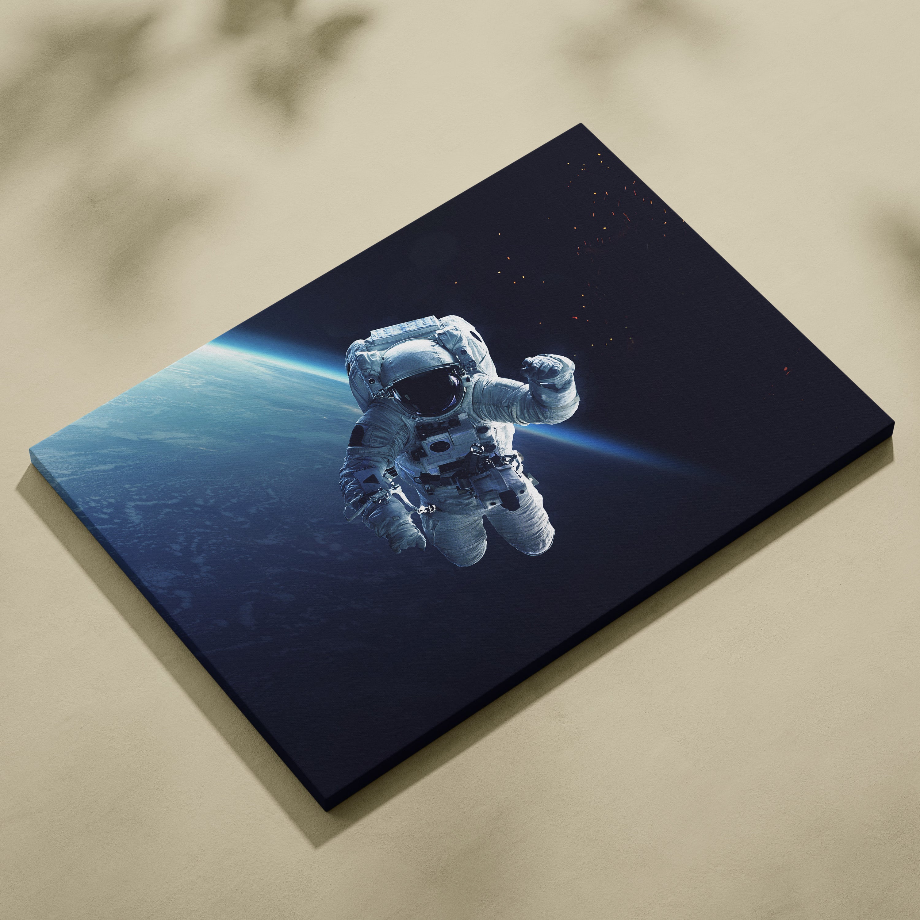 A sleek rectangular canvas print of a white astronaut floating in space with blue earth horizon for modern decor