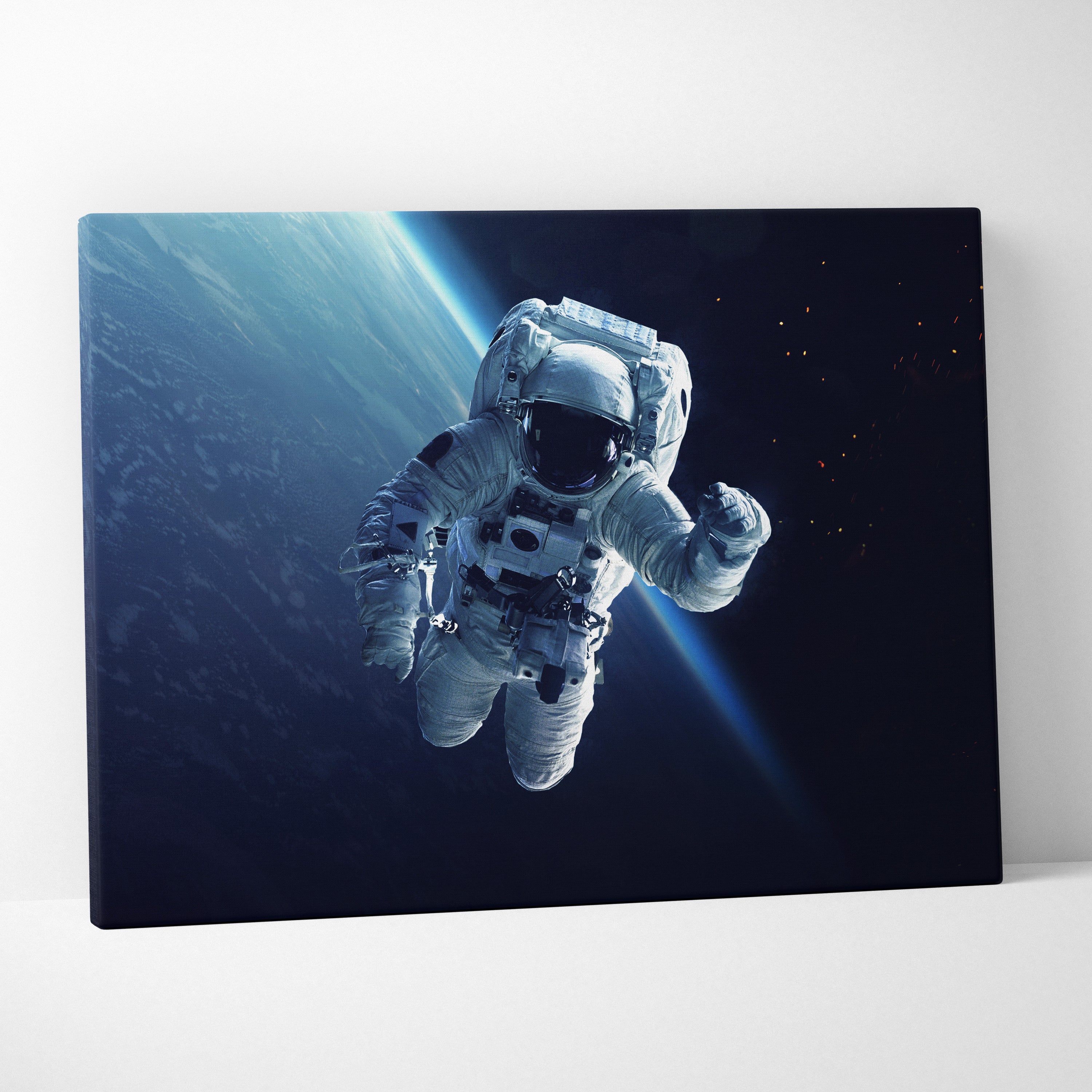 Astronaut in space canvas wall art print featuring a white astronaut in a detailed suit with blue light rays backdrop