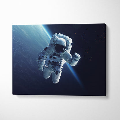 Astronaut in space canvas wall art print showing a white suited astronaut floating with blue light rays in earth orbit