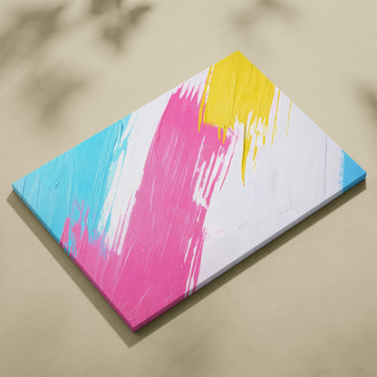 A vibrant abstract canvas wall art print with bold pink yellow and cyan brushstrokes for modern living room decor