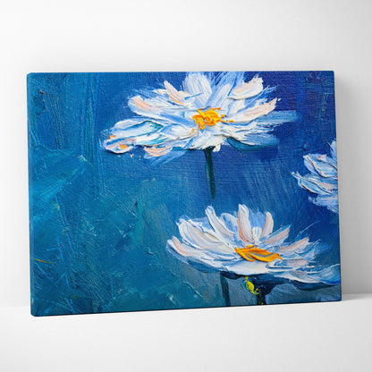 Blue textured canvas wall art featuring two white daisies with yellow centers in bold impasto brushstrokes