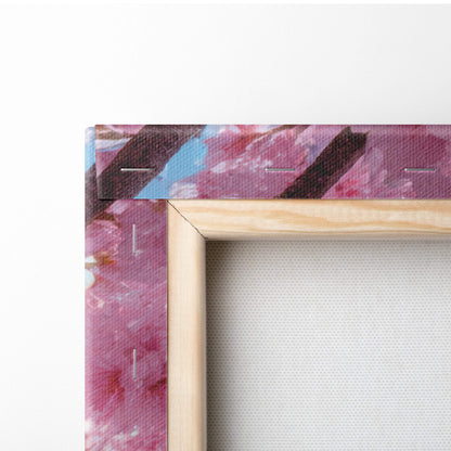 A wooden frame pink cherry blossom sky canvas wall art with vibrant swirling pink purple and blue brushstrokes