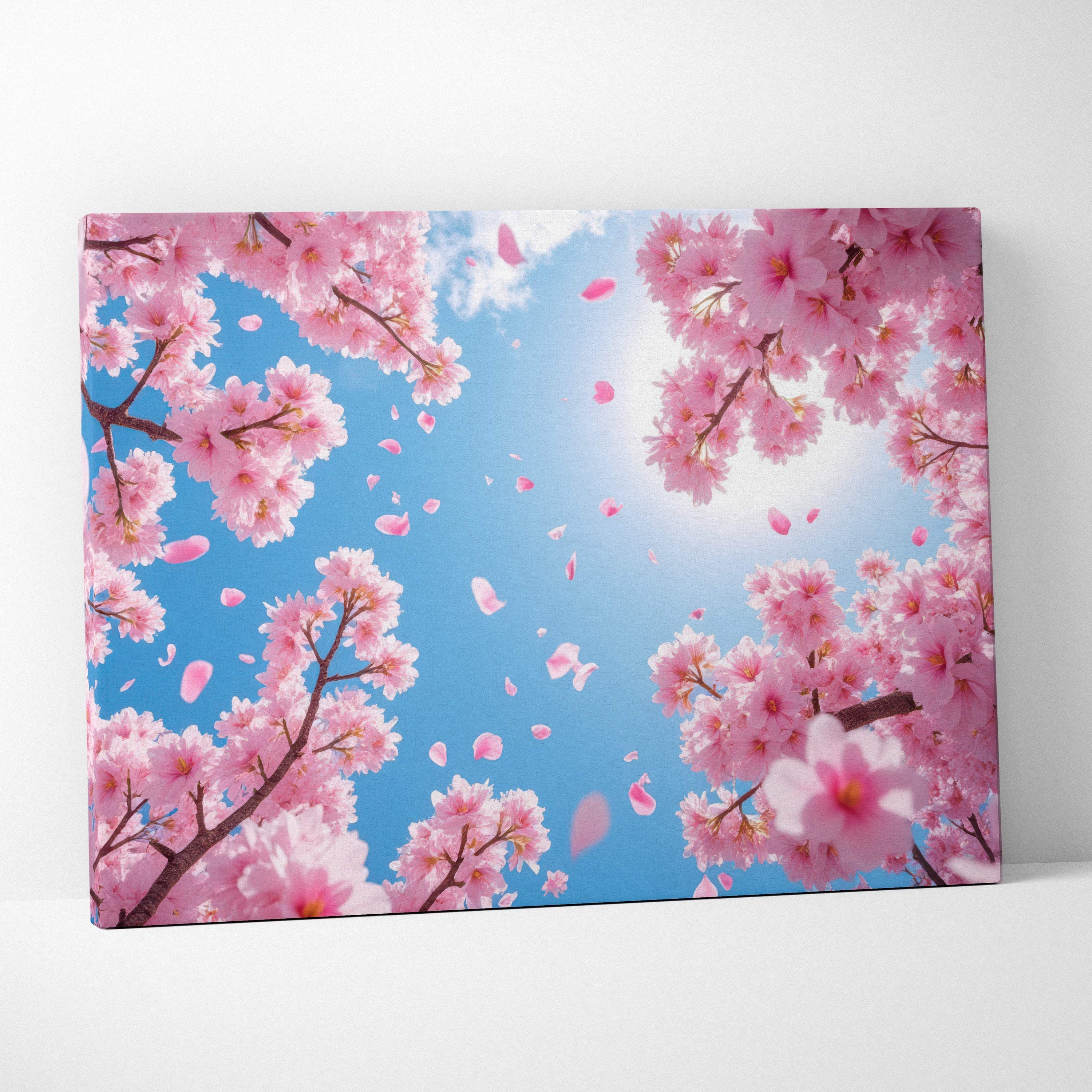 Rectangular canvas wall art featuring vibrant pink cherry blossoms and falling petals against a bright blue spring sky