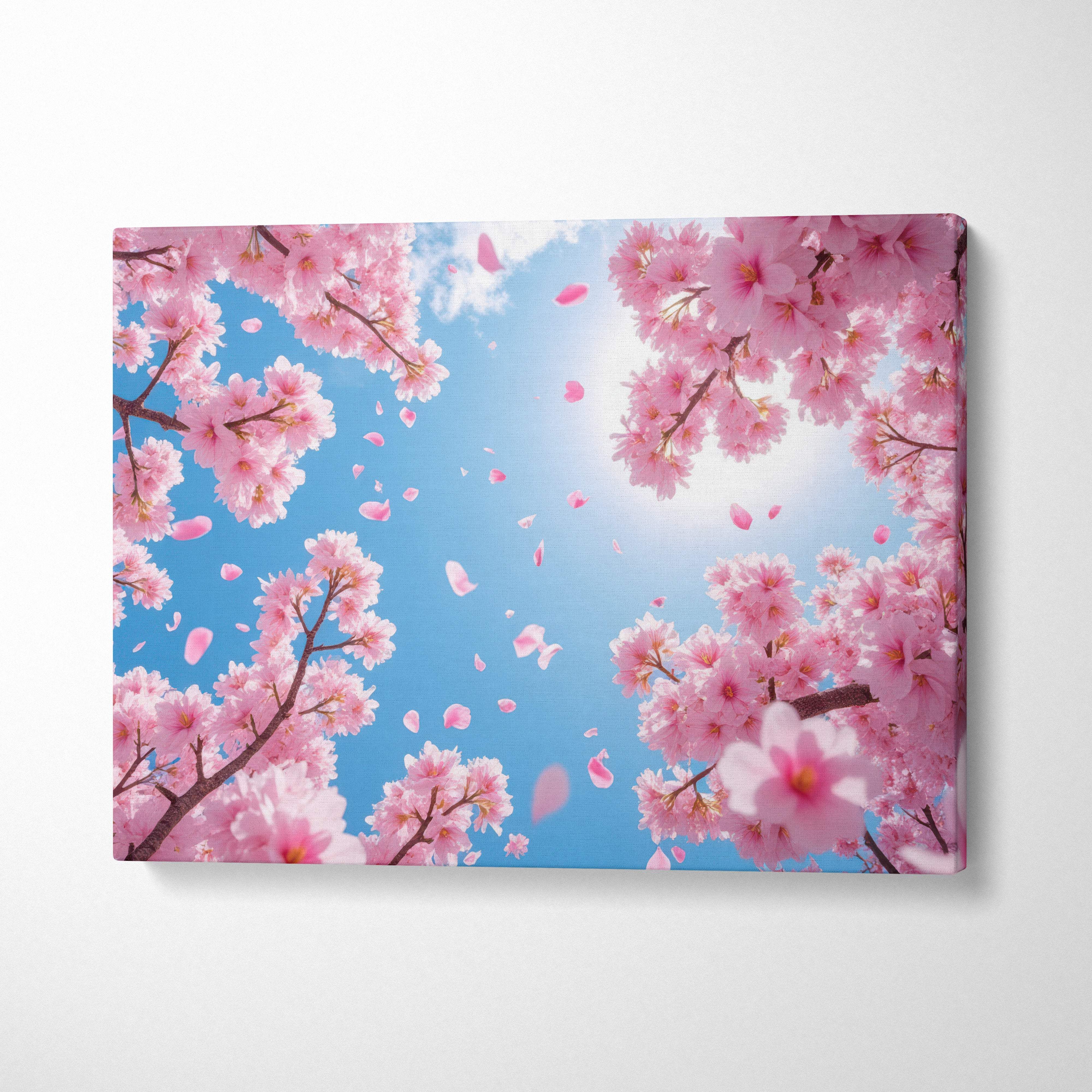 Rectangular canvas print of pink cherry blossoms against a bright blue spring sky with falling sakura petals decor