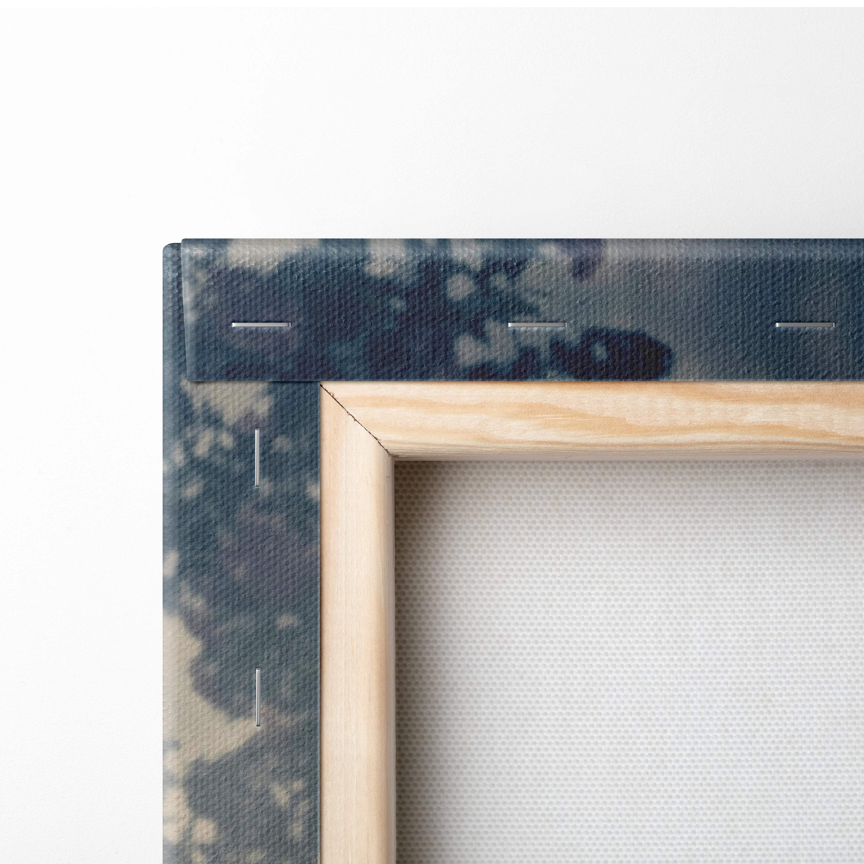 Minimalist wooden frame with a natural finish holding a dark blue and beige tie-dye canvas for rustic cabin decor