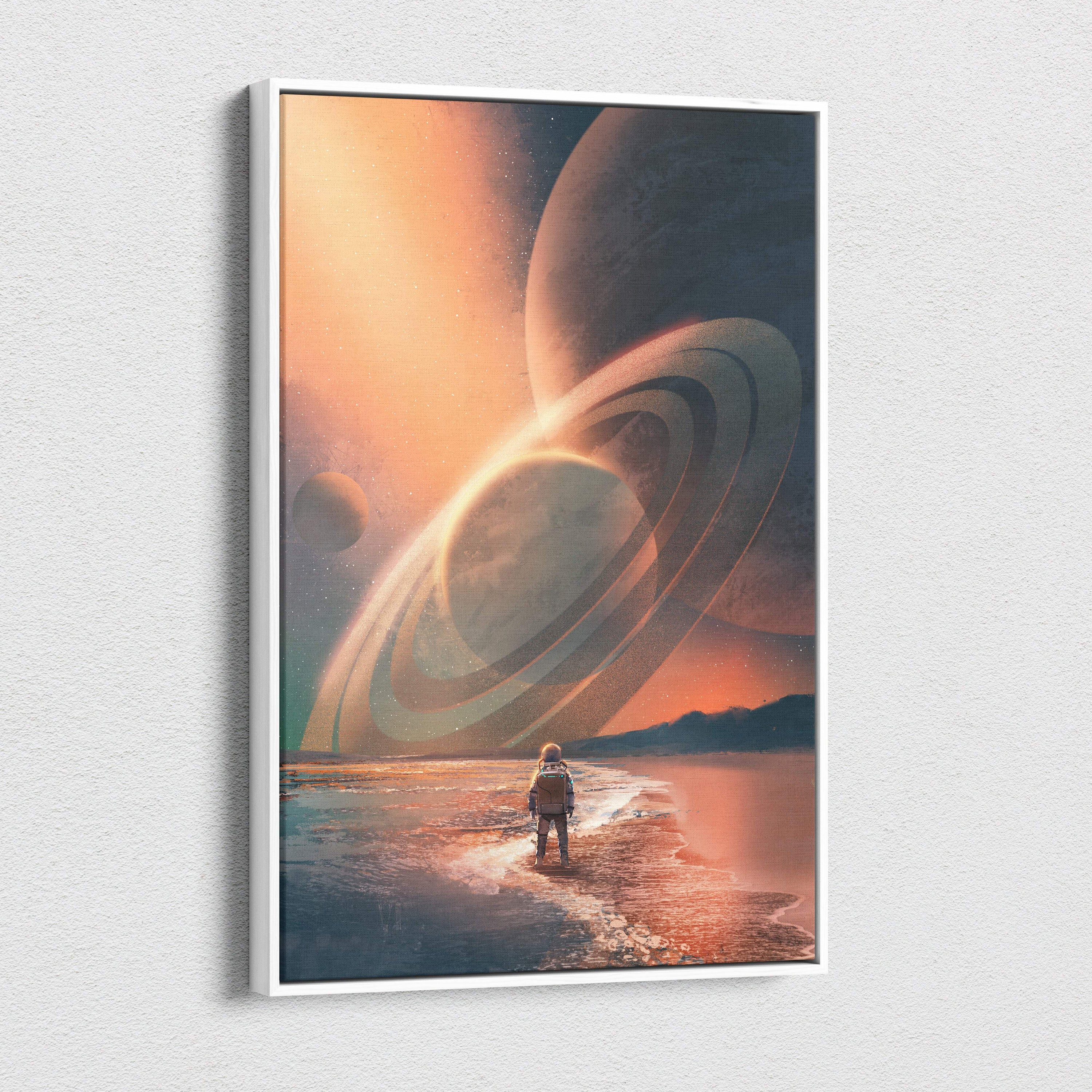 A framed canvas print of a lone astronaut on a beach with orange sky and giant ringed planets cosmic horizon explorer wall art