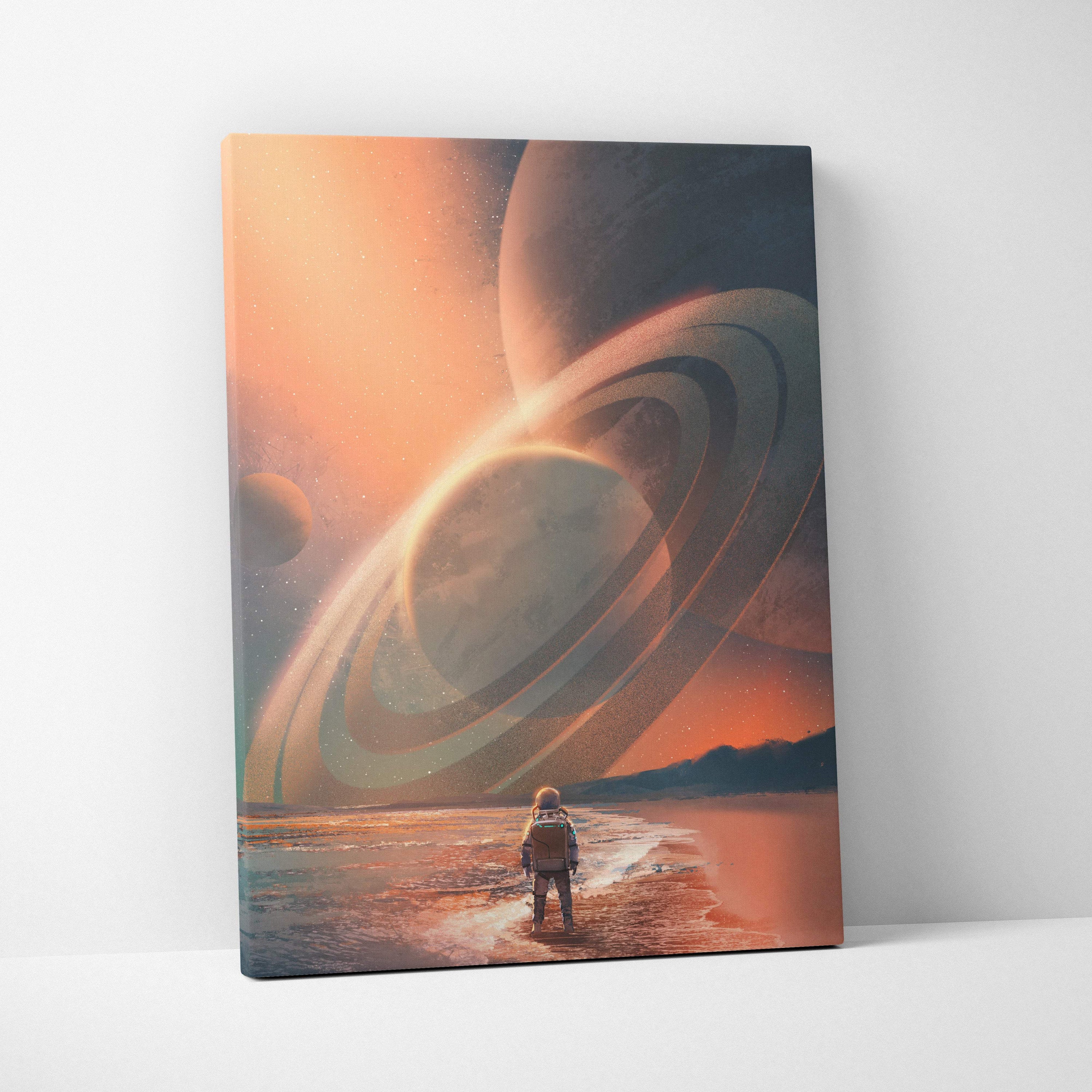 A rectangular canvas print of a lone astronaut on a beach under an orange sky with giant ringed planets in the distance