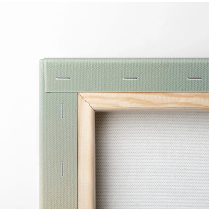 Close-up of stretched canvas corner showing wooden frame and green fabric backing for wall art.