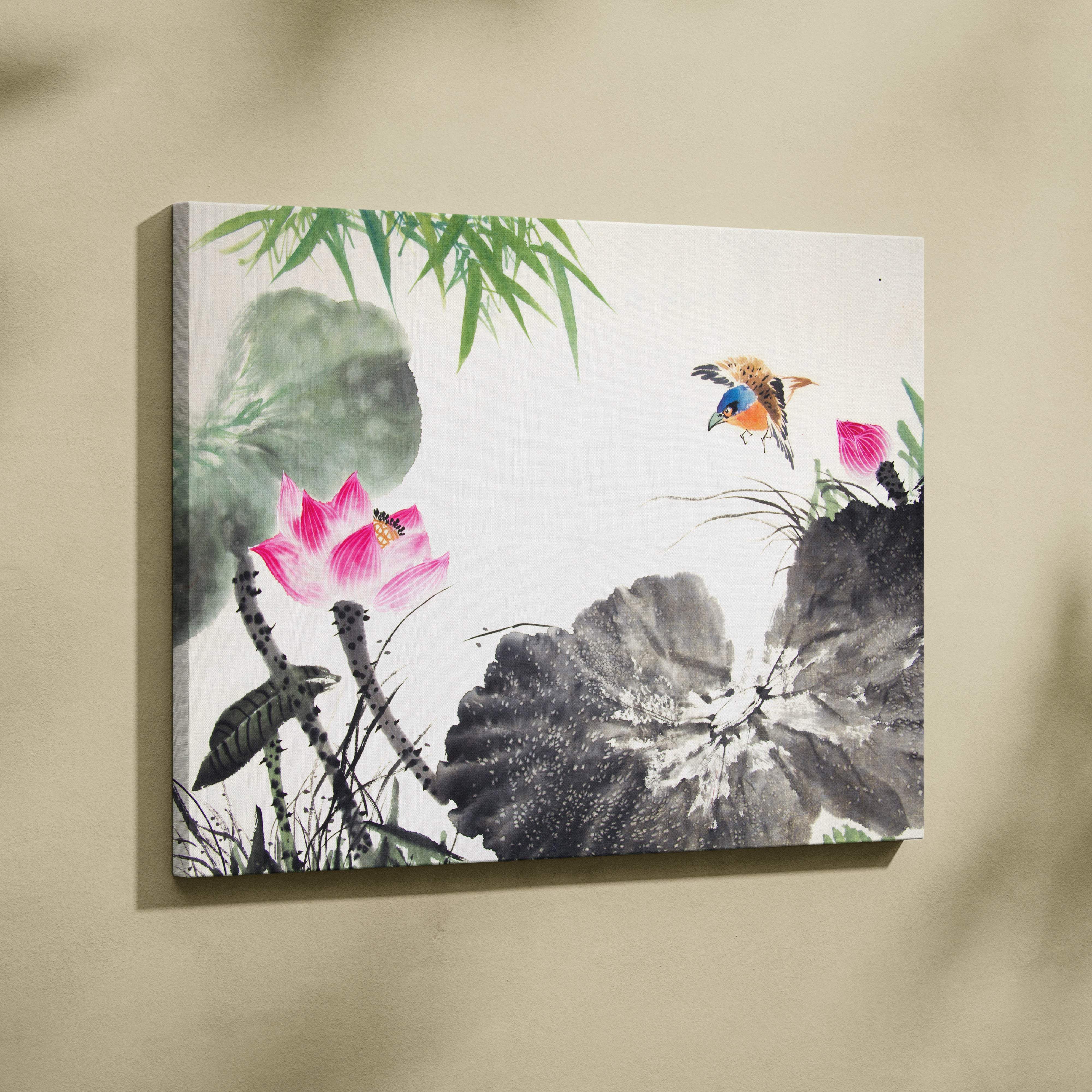 A framed canvas wall art featuring a vibrant pink lotus flower green bamboo leaves and a colorful bird in a watercolor style