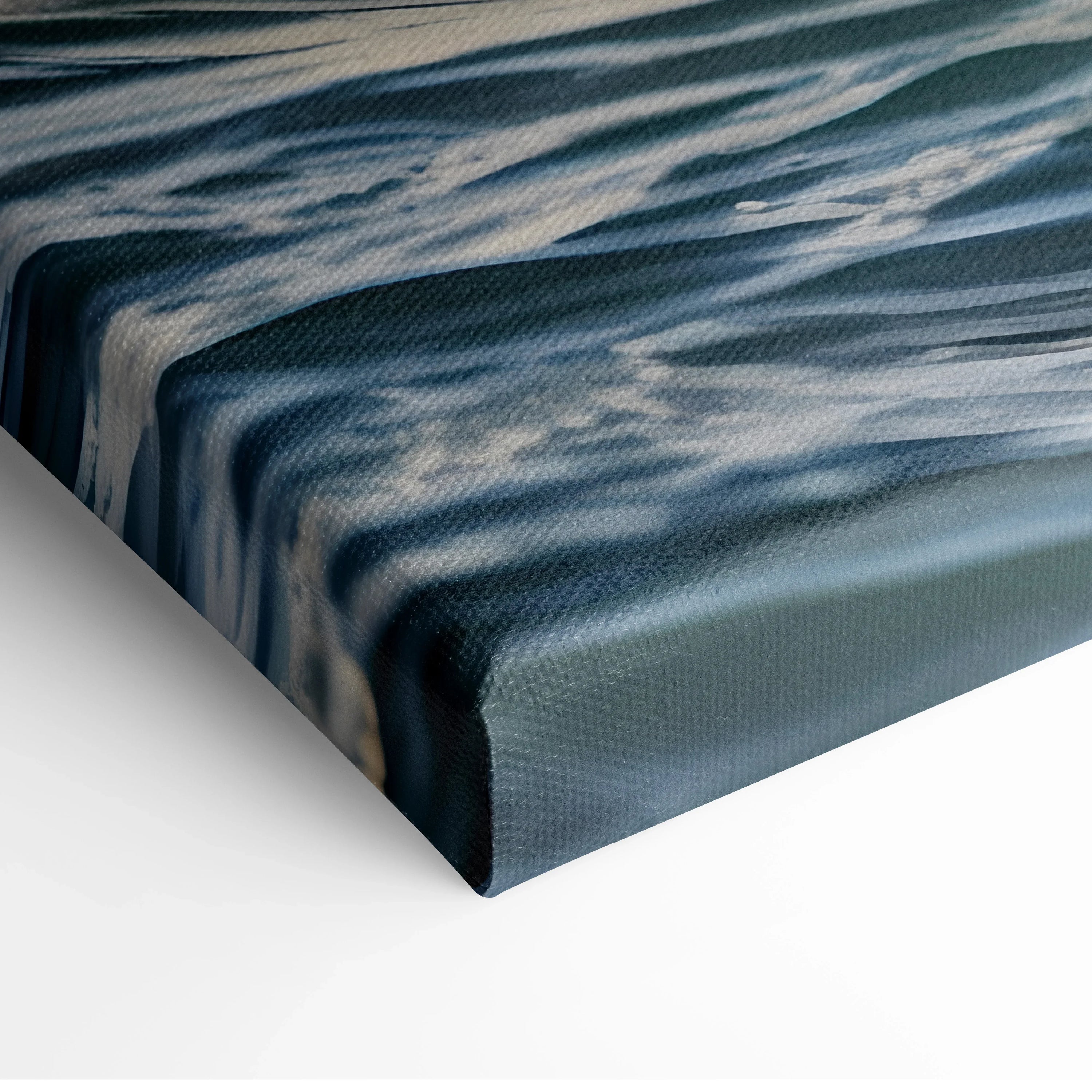 Close-up of textured canvas wall art featuring tranquil ocean watercolor waves in blue and white tones.