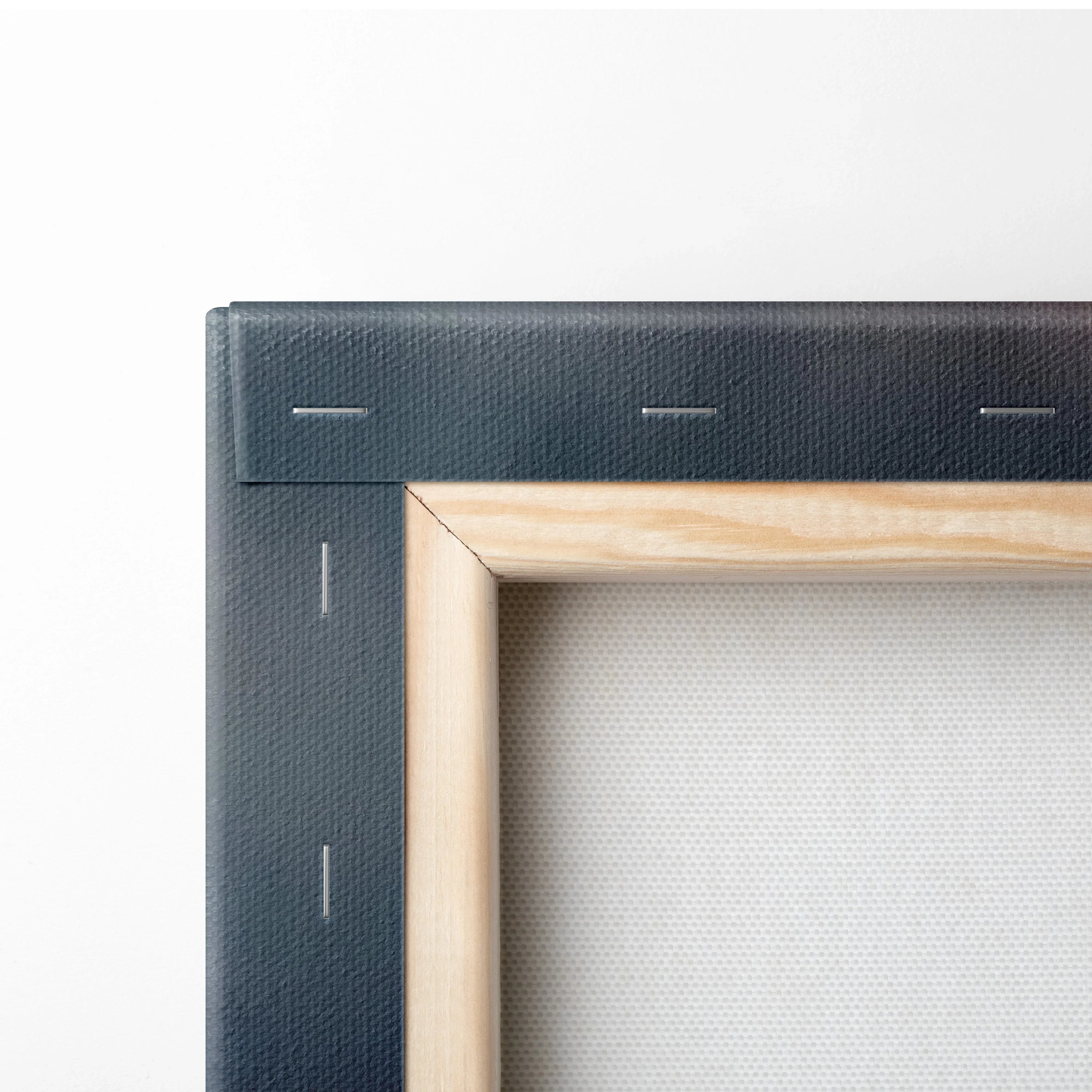 Close-up of wooden stretcher bars and canvas fabric on the back of stretched wall art canvas.