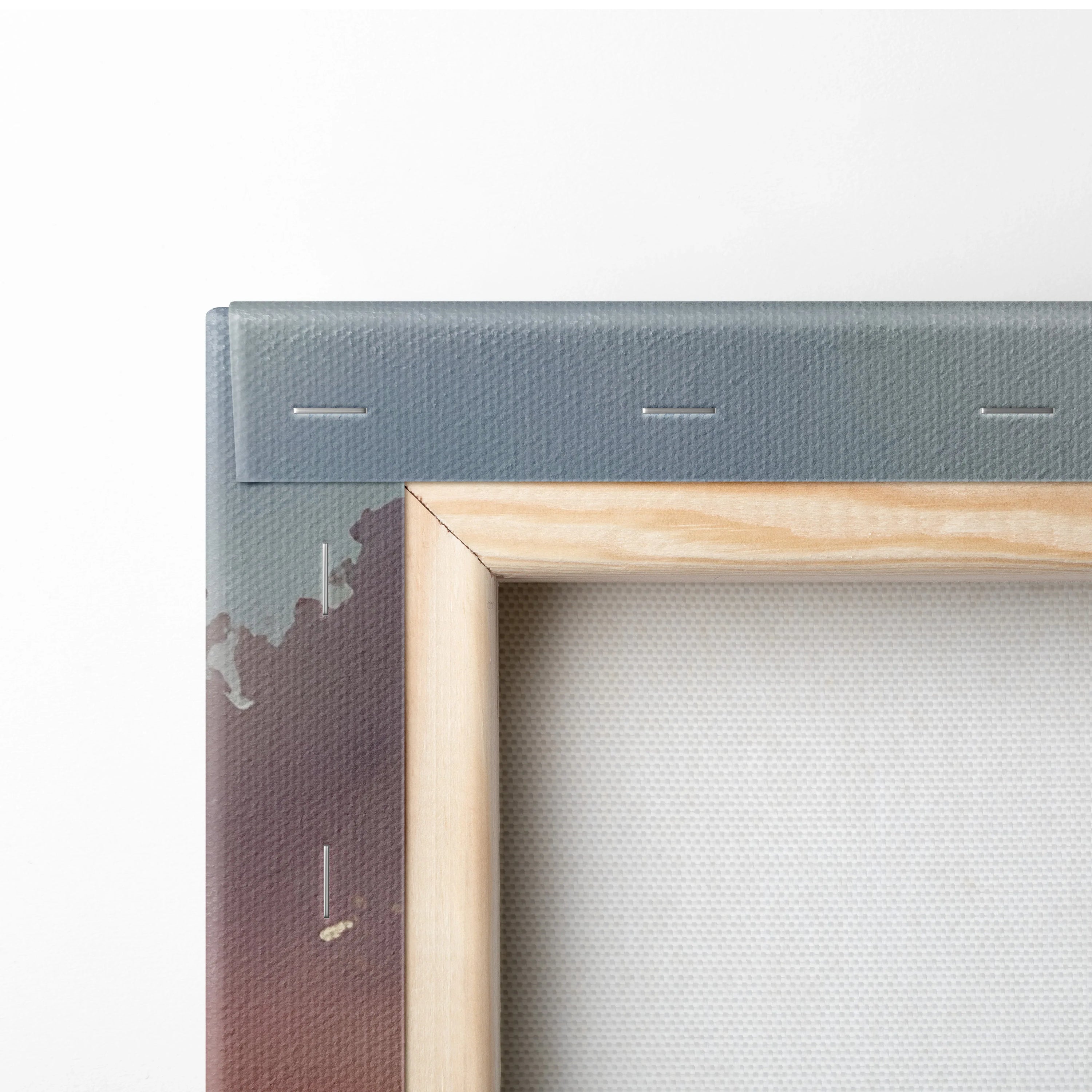 Close-up of wooden frame and stapled canvas backing on horizontal wall art panel.