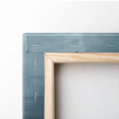 A light blue canvas with natural wood frame and visible stitching in a green yellow abstract tropical geometric wall art