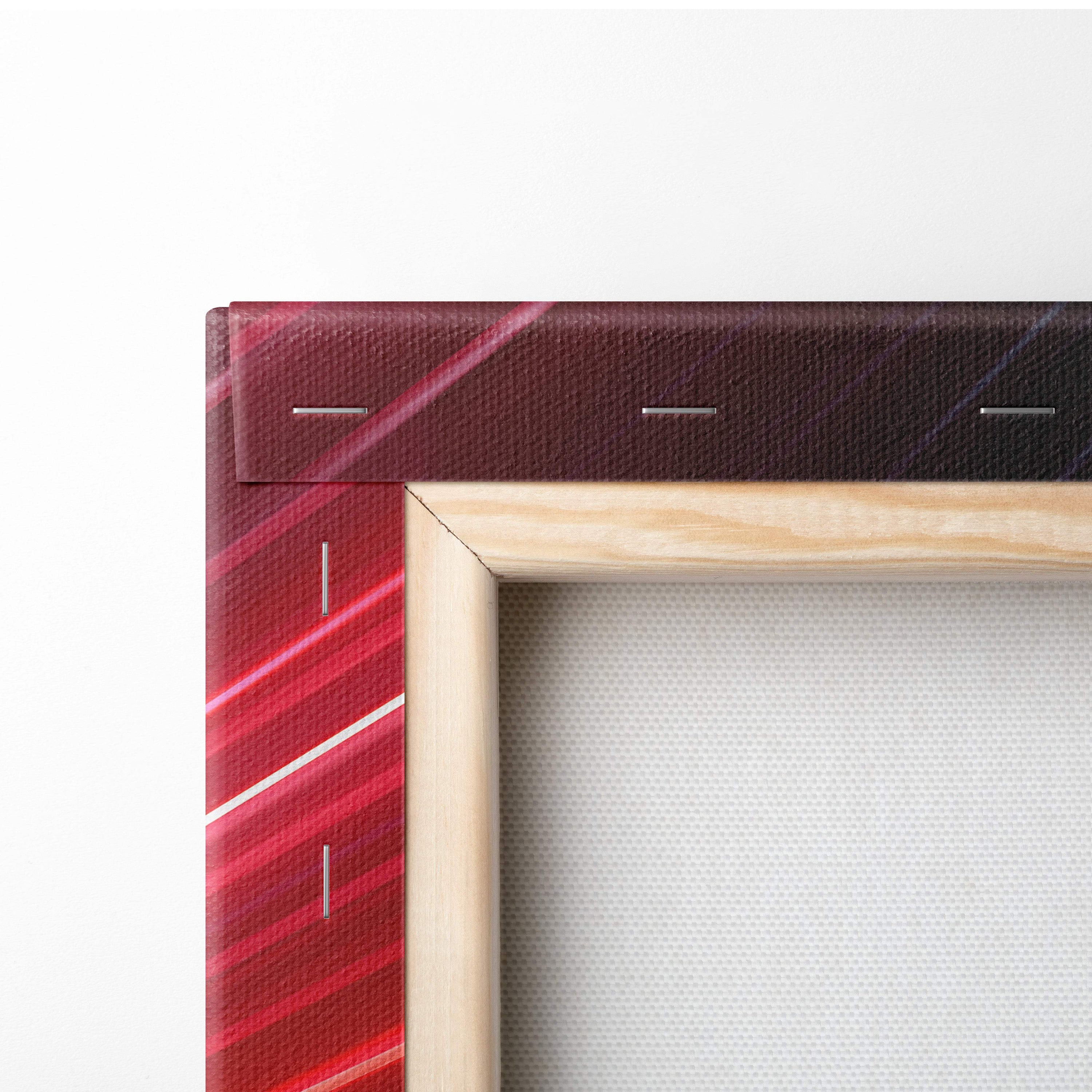 A canvas print of a red supercar speeding through neon light trails with a bold red and maroon striped wood frame