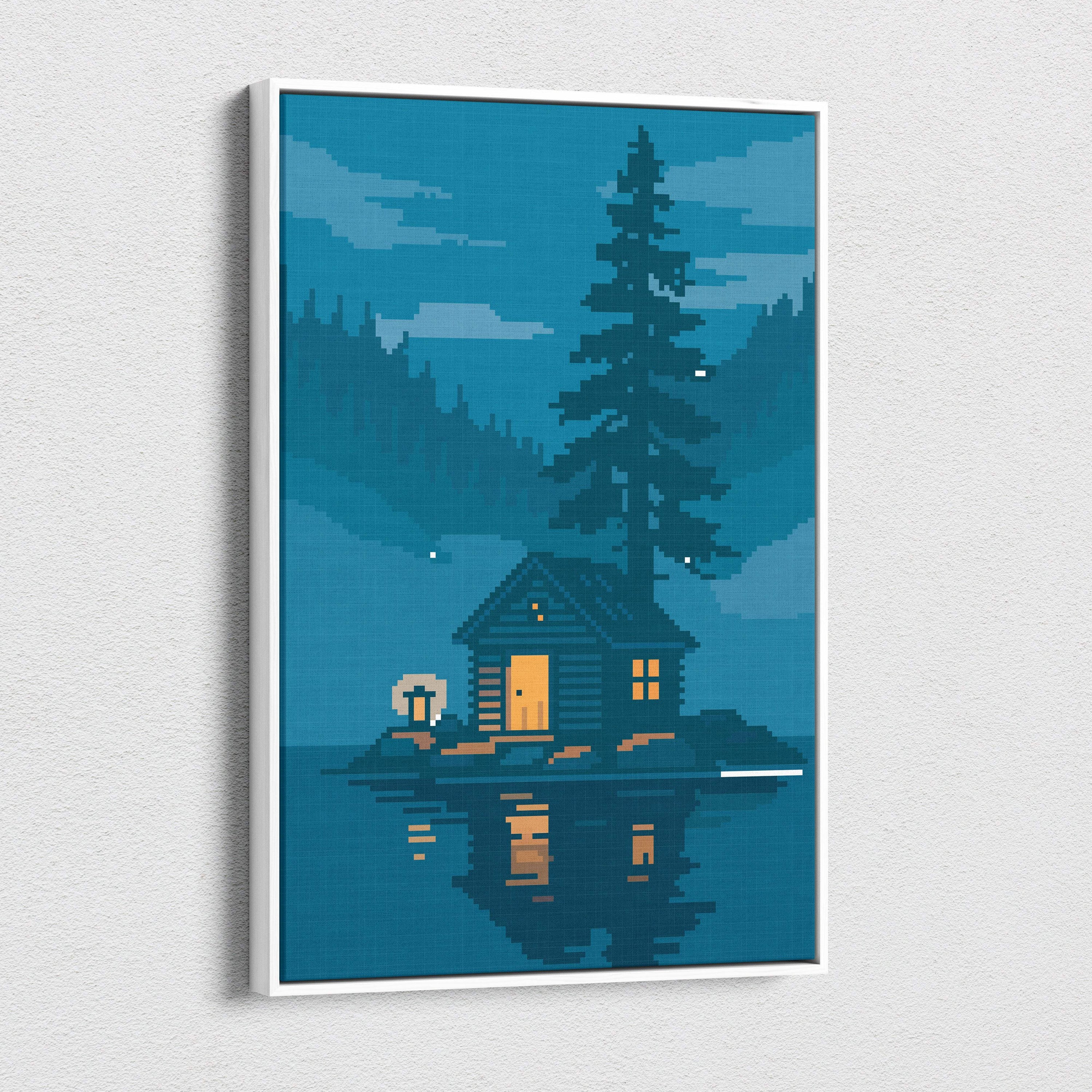 A framed cozy cabin pixel art canvas print featuring warm yellow lights on a blue lake forest at night