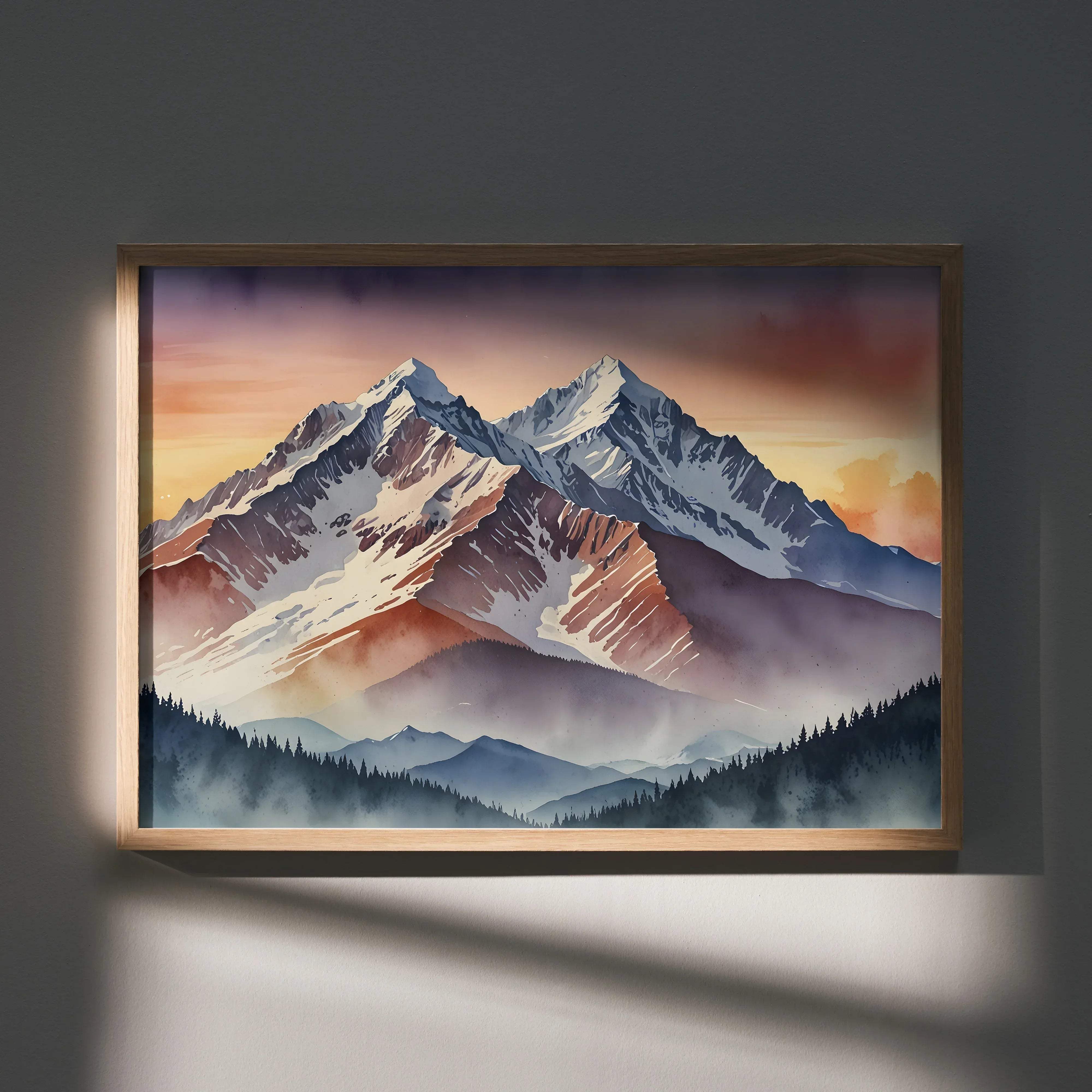 A framed watercolor style art poster of snow-capped mountains at sunset with orange and purple skies and pine forests