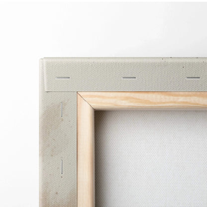Close-up of wooden frame and blank white canvas for wall art.