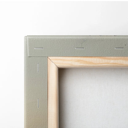 Close-up of wooden stretcher frame with gray canvas wrapped for wall art.