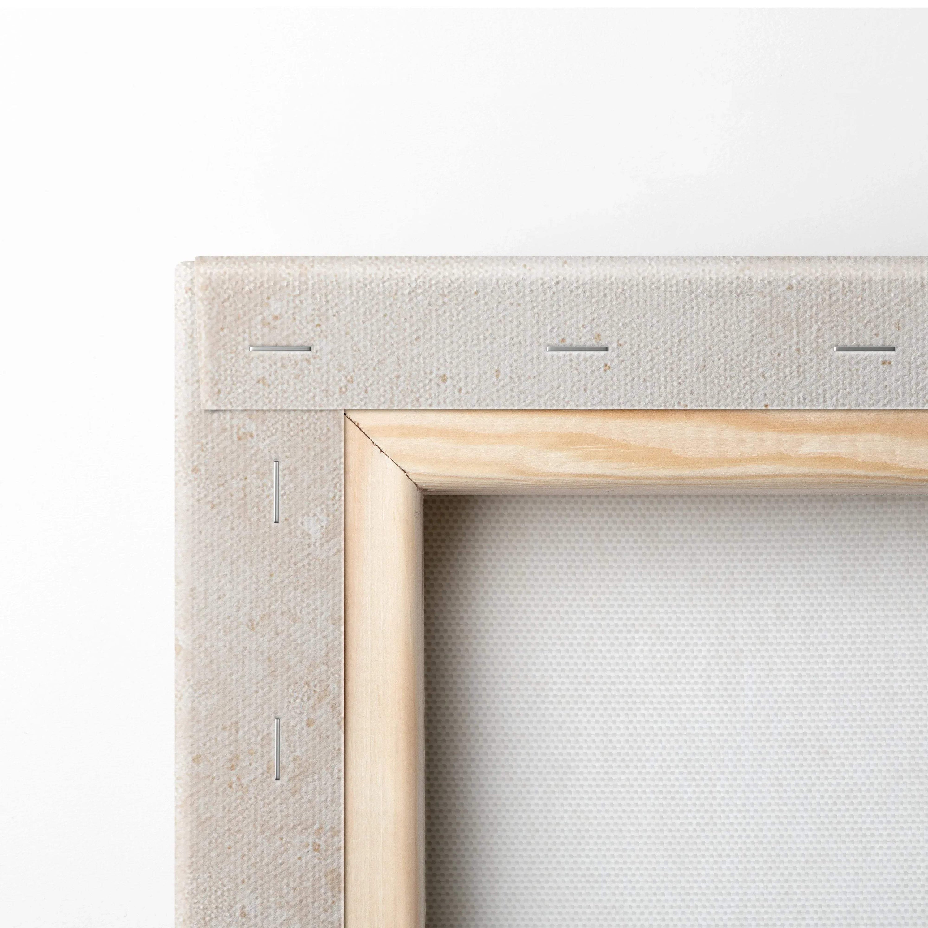 Close-up of wooden frame corner and stapled edge on canvas wall art print.
