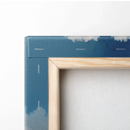Corner detail of wooden frame on blue canvas wall art with stapled edges.