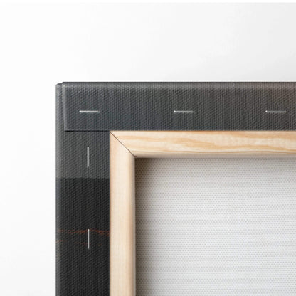Close-up of natural wood frame corner on stretched canvas wall art with visible canvas texture and black stapled stretcher.