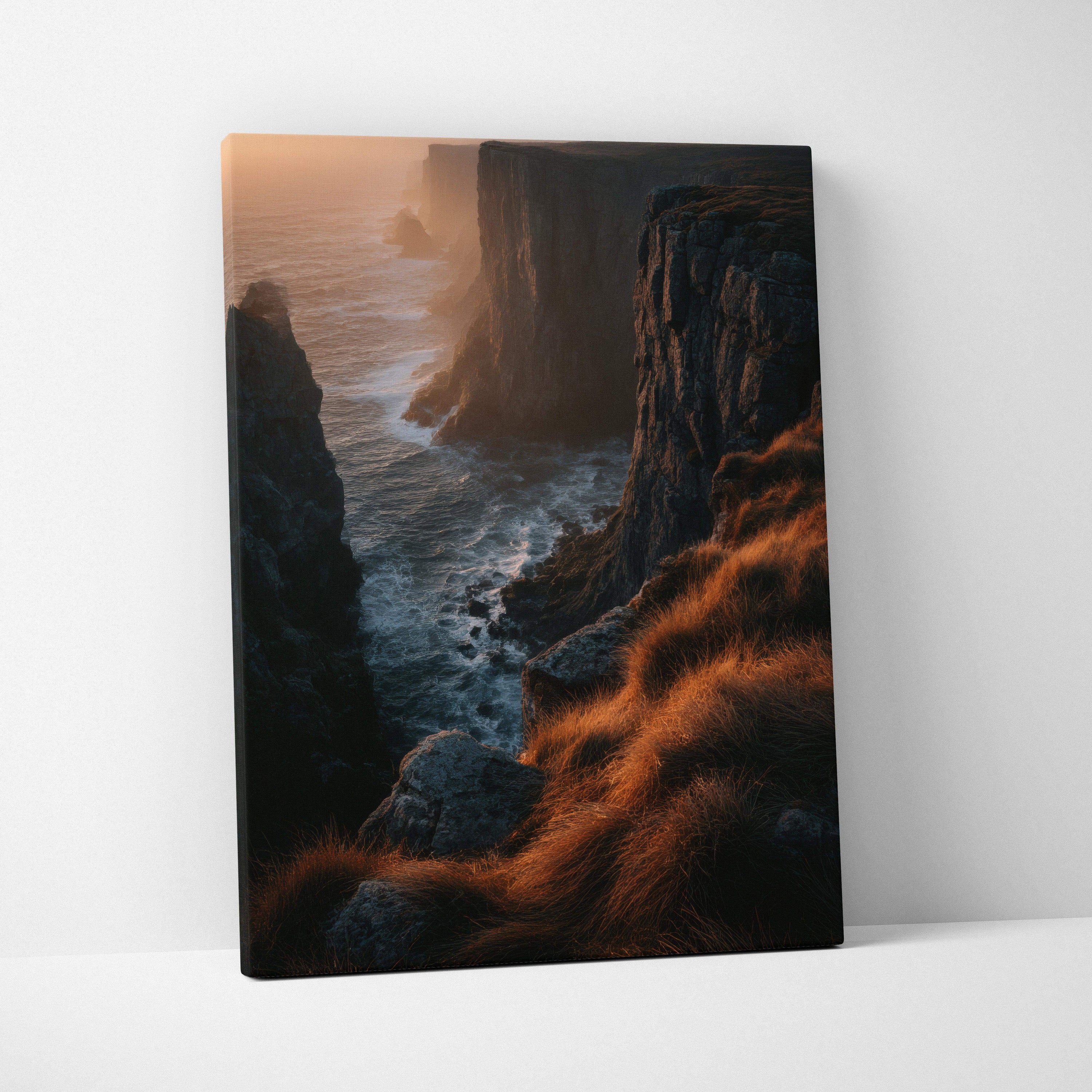 Canvas wall art featuring a dramatic sunset over rugged cliffs with golden grass and ocean waves.
