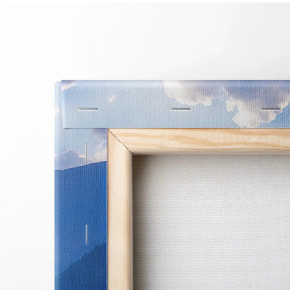 Close-up of wooden framed canvas wall art with blue and white nature-inspired print and visible staples.